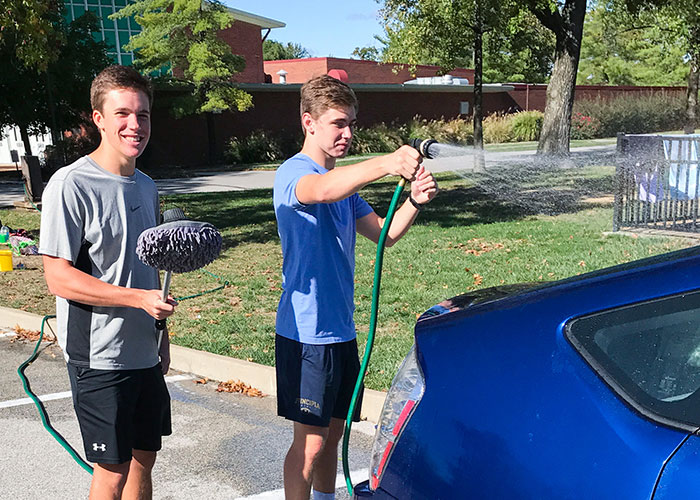 Jack and Jeremy washing a blue car